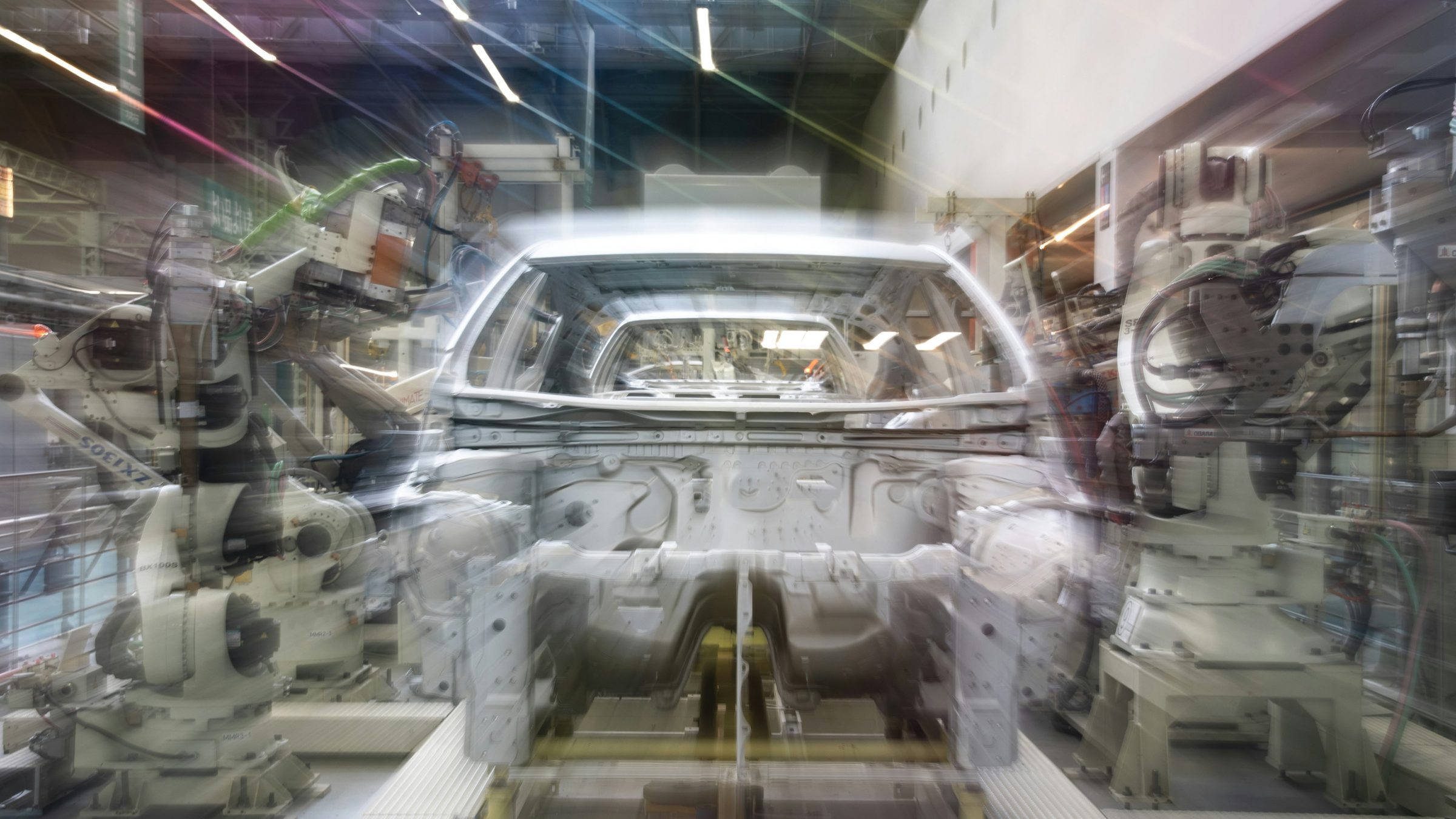 Car assembly line with robotic arms. Photo: Lilian Do Khac / Unsplash