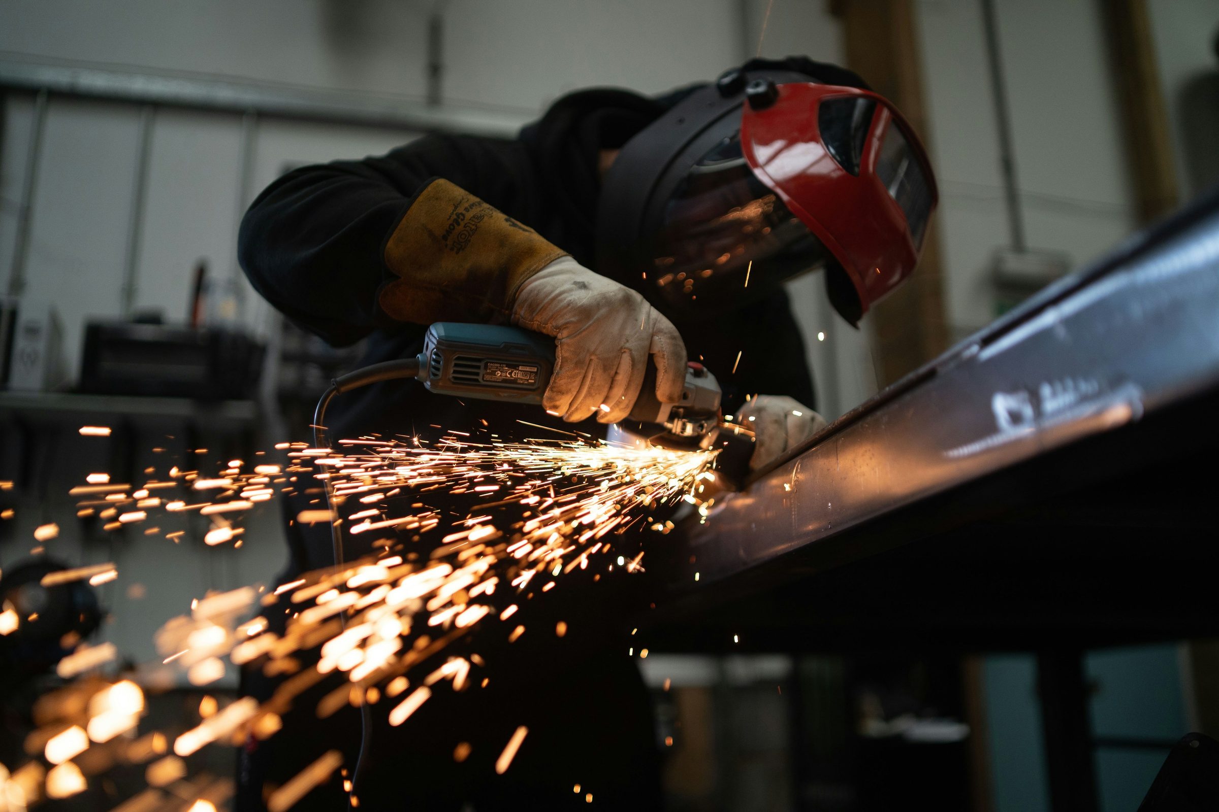 Welder grinding a metal beam with sparks. Photo: Josh Beech / Unsplash