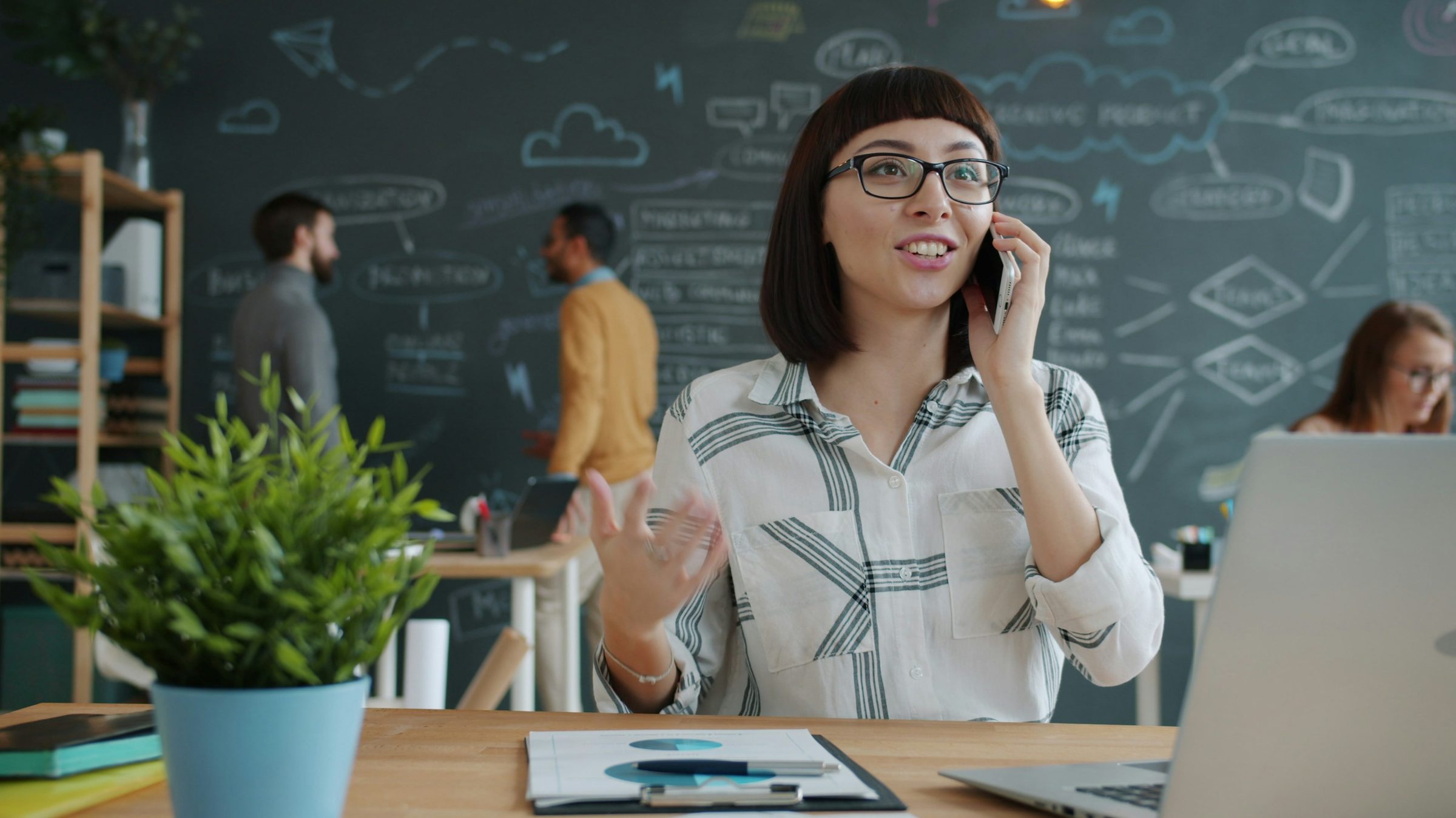 Woman talking on the phone in a modern office. Photo: Vitaly Gariev / Unsplash
